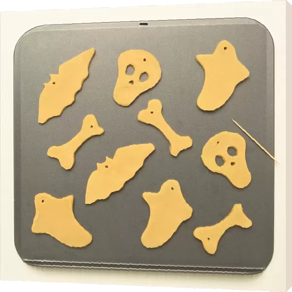 Halloween, ghostly shaped biscuits on a baking tray