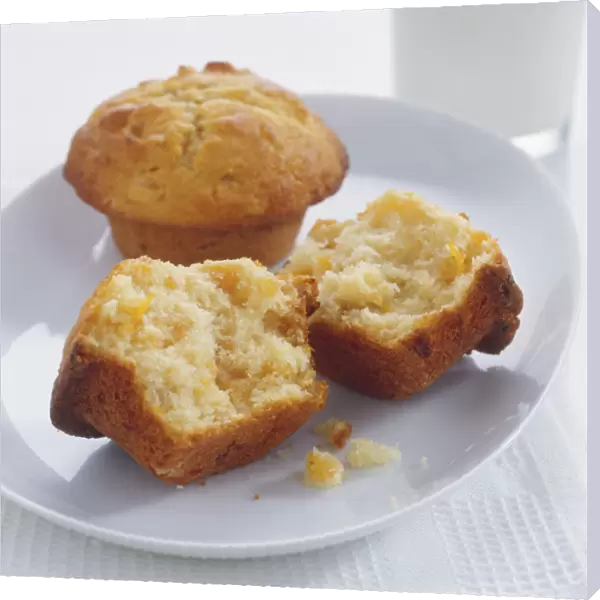 Apricot Muffins, whole and broken in two, served on a plate