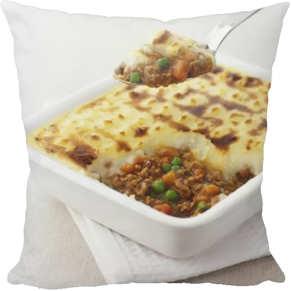 Shepherds pie being spooned out of square dish, close up