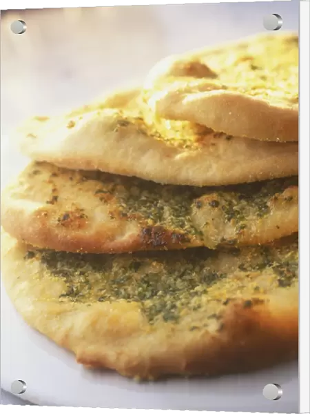 Stacked garlic bread, sprinkled with herbs
