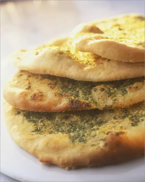 Stacked garlic bread, sprinkled with herbs