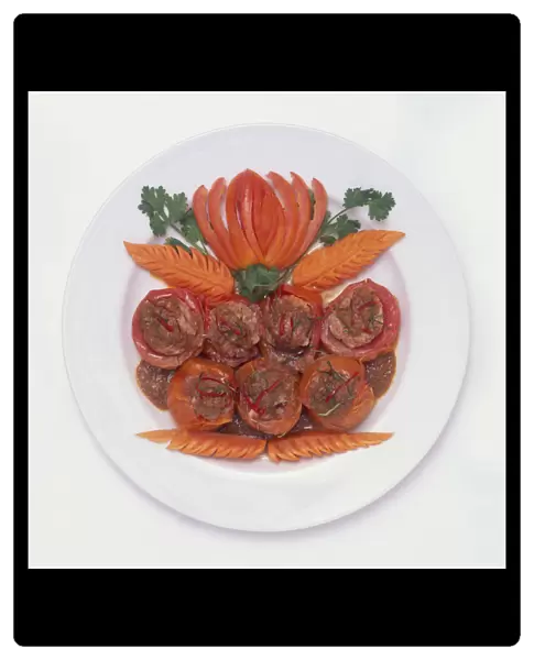 Phanaeng Kung Makheuathet, tomatoes stuffed with prawn and curry arranged on a plate with vegetable decorations, a typical dish from Hat Yai and Phuket, Thailand, view from above