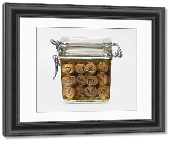 Home made pickled anchovies in oil in airtight square glass jar