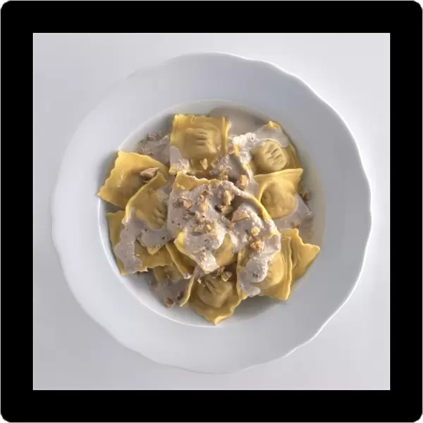 Pansoti served with walnut and ricotta sauce, a typical stuffed pasta dish from Liguria, Italy, view from above