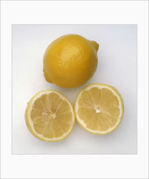 Citrus limon Primafiori (Primafiori lemon), one whole and one sliced in two