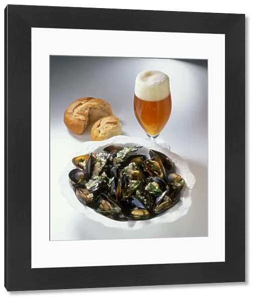Bowl of mussels cooked in India Pale Ale, glass of India Pale Ale and bread roll