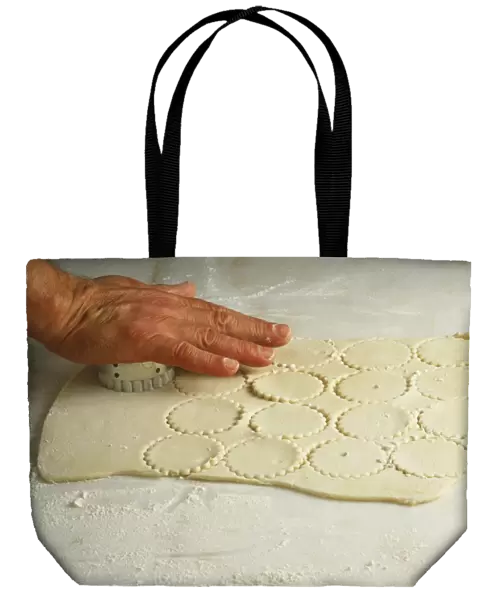 Stamping out rounds in the dough, using a pastry cutter