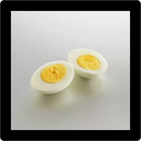 Two halves showing the yolks of a hard boiled egg