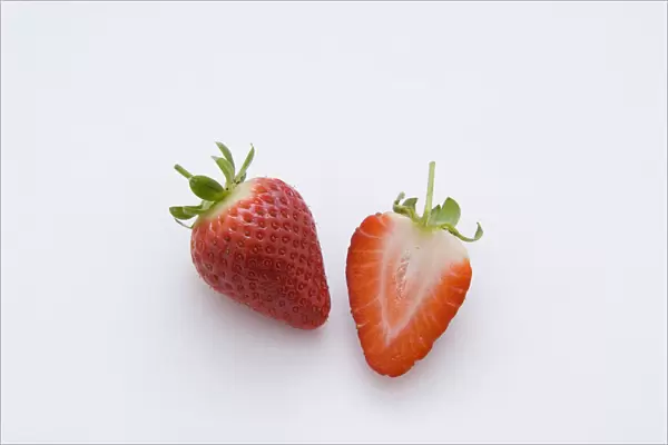 One strawberry and half strawberry, close-up
