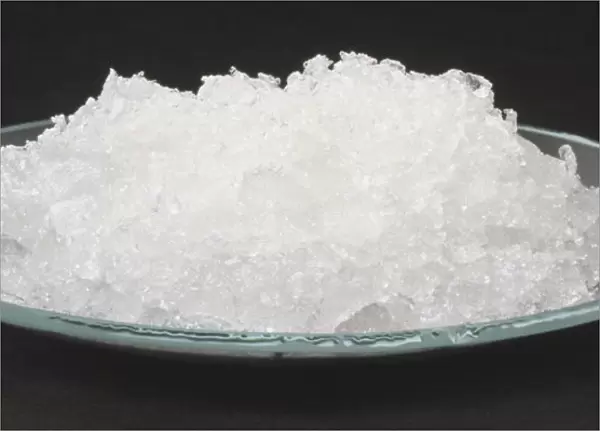 White crystals of sodium carbonate decahydrate, washing soda, in watch glass