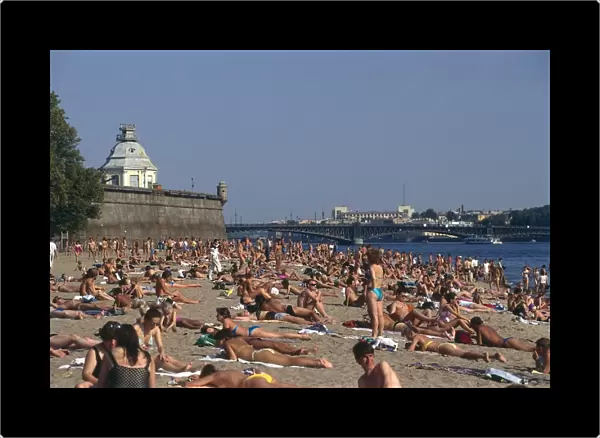 Russia, St Petersburg, the beach outside the Peter and Paul Fortress, full of people sunbathing