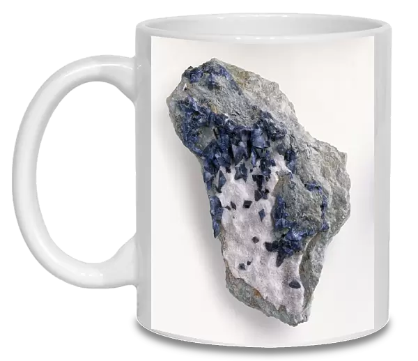 Blue benitoite crystals and white natrolite in rock groundmass