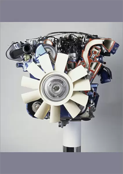 Front view of a V12 petrol engine with white fan at the front