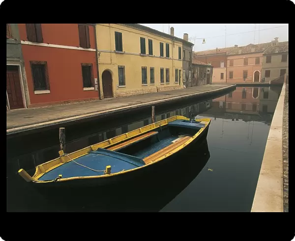 Italy, Emilia-Romagna Region, Comacchio (Ferrara Province), Po Delta Regional Park, Coloured batana boat along canal