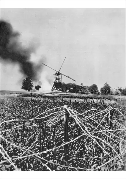 World War I 1914-1918: Windmill destroyed by German shellfire. Barbed wire defences in foreground