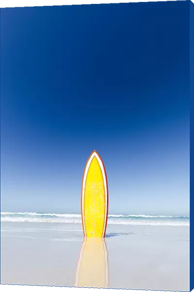 Retro yellow surf board and blue sky. Australia