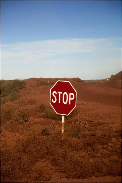 A stop sign at an intersection in a desert