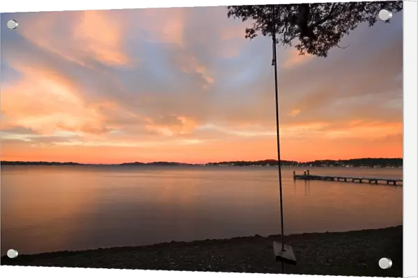 swing overlooking the lake at sunrise