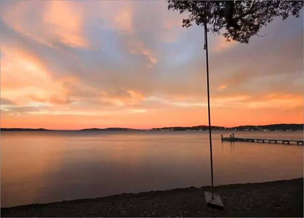 swing overlooking the lake at sunrise