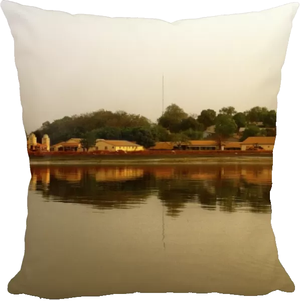 River Gambia at sunset with Tendaba settlement reflections on calm water during sunset