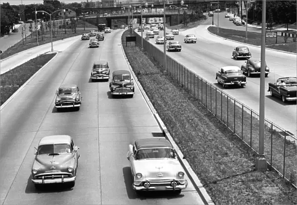 Various American autos on highway