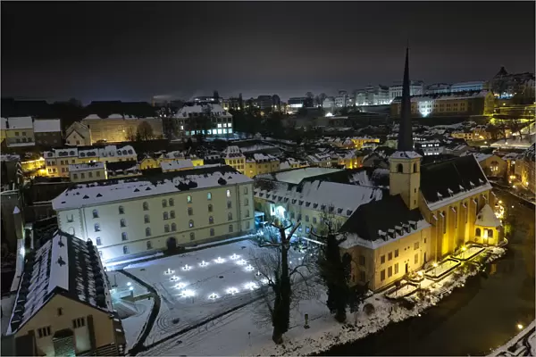 Neumunster Abbey in Luxembourg at night under snow