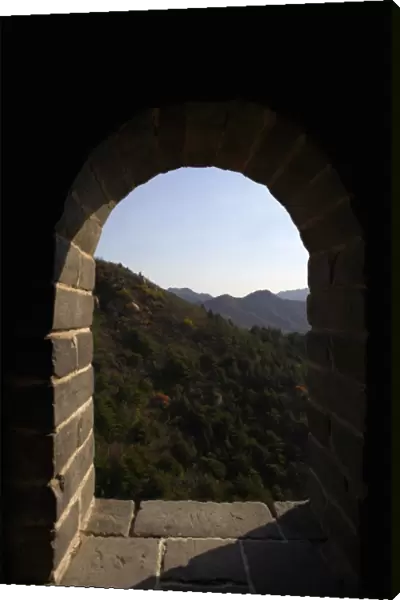 A scenic shot through a window on an outpost on the Great Wall of China