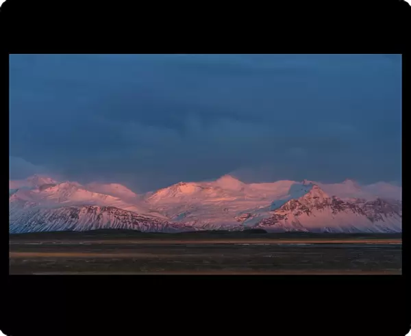 Snow mountain range in Iceland during sunset period