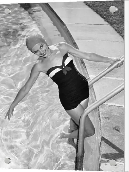 Woman in swimming pool posing on steps