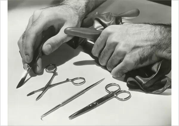 Man arranging surgical tools, close up of hands