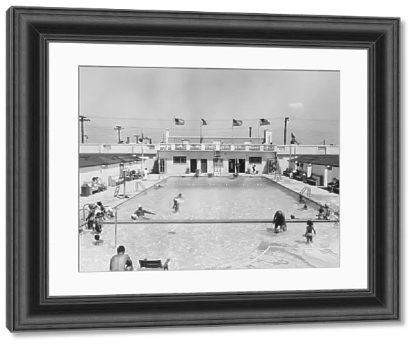 People relaxing in outdoor pool (B&W), elevated view