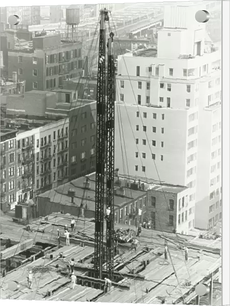 Workers on building site on urban setting, (B&W), elevated view