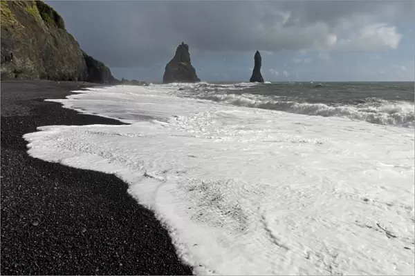 Surf on the black lava beach of Reynisfjara, Reynisdrangar Pinnacles, near Vik i Myrdal, South Coast, Iceland