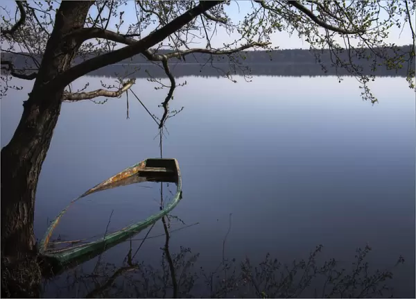 A sunken rowing boat in the lake of Moryn, Poland, Europe