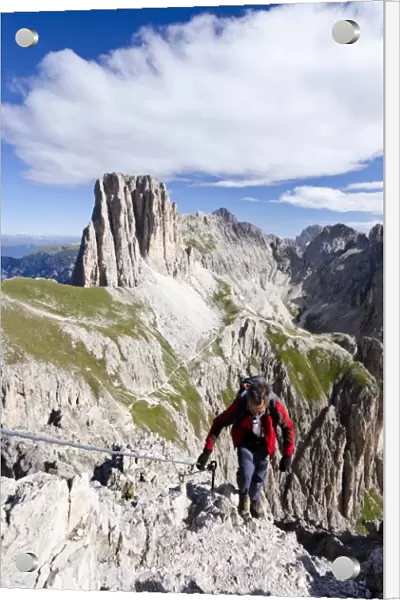 Climbers during the ascent to the Croda Rossa in the Rose Garden Group over the Croda Rossa via ferrata, below the Vaiolonpass, behind the Tscheiner peaks, Dolomites, Province of South Tyrol, Italy