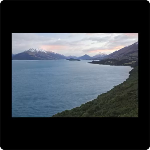 Lake Wakatipu in front of a mountain range at sunrise, Otago Region, South Island, New Zealand