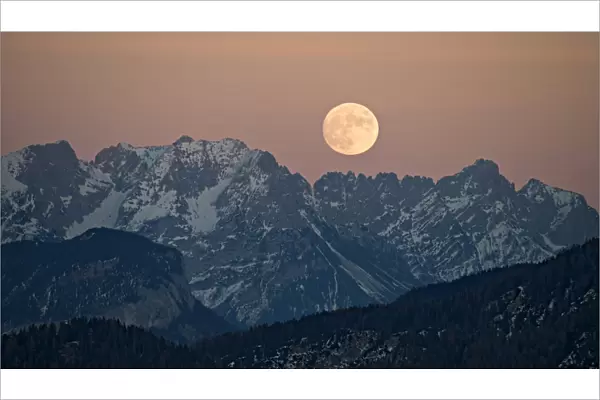 The full moon rising over the Kaiser Mountains, Tyrol, Austria