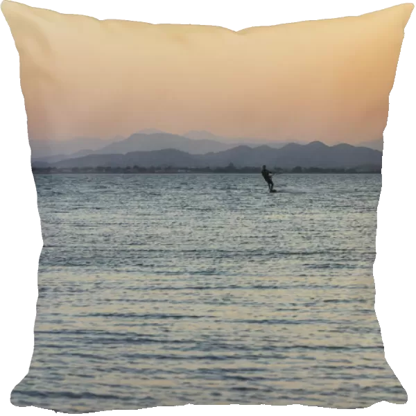Kitesurfer, surfing on the blue lagoon of Ras Al Hadd Lagoon in the evening light, Ras Al Hadd, Ash Sharqiyah, Oman