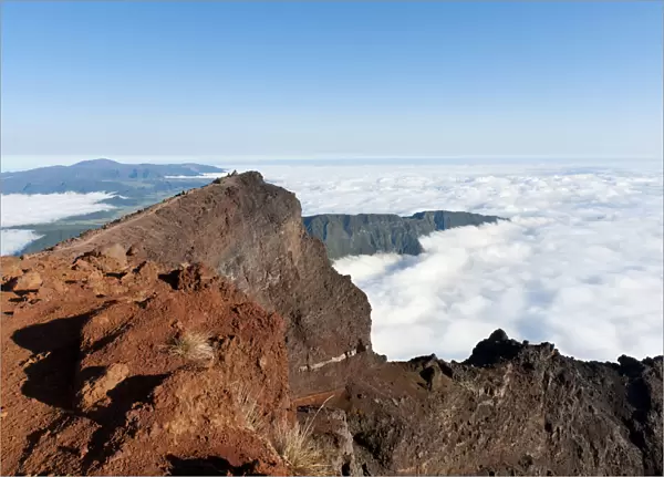 Red volcanic rock on the summit, Piton des Neiges Mountain, 3069 m, above the clouds, near Cilaos, French Overseas Territory, La Reunion