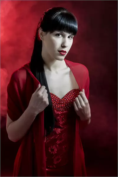 Young woman with long black hair in a red dress