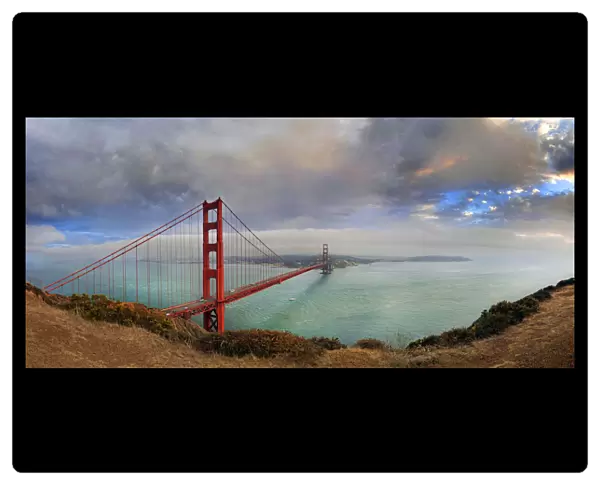 Golden Gate Bridge at sunset with storm clouds, San Francisco, California, United States