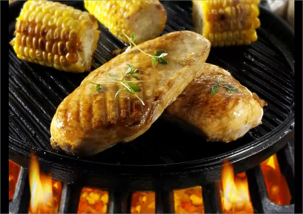Chicken breast and corn on a barbecue