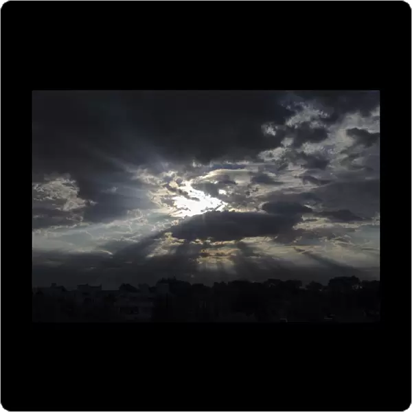 Sky with clouds and rays of sunshine, moody atmosphere