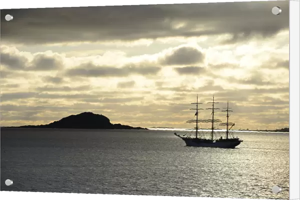 Ship sailing past an island at sunset, Insel Havsteinen, Alesund, More og Romsdal, Western Norway, Norway