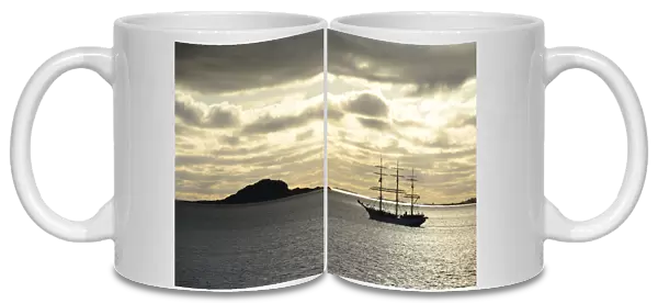 Ship sailing past an island at sunset, Insel Havsteinen, Alesund, More og Romsdal, Western Norway, Norway