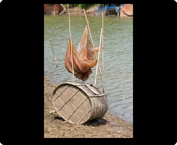 Fish trap made of bamboo and a fishing net on the Sangkae river, Battambang, Cambodia, Southeast Asia