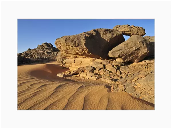 Sandstone rock formation and sand dunes, Adrar Tekemberet, Immidir, Algeria, Sahara, North Africa
