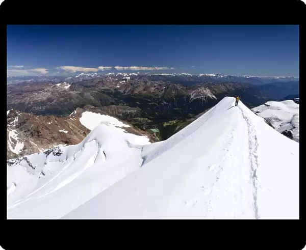 Climber descending Mt Piz Palu, on the summit ridge, Grisons, Switzerland, Europe