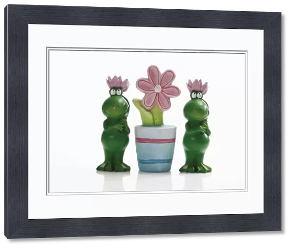 Two frog figures with artificial flower pot