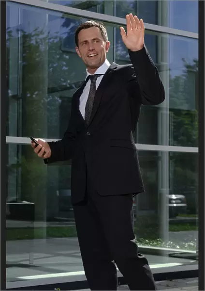 Business man greeting someone outside a bank